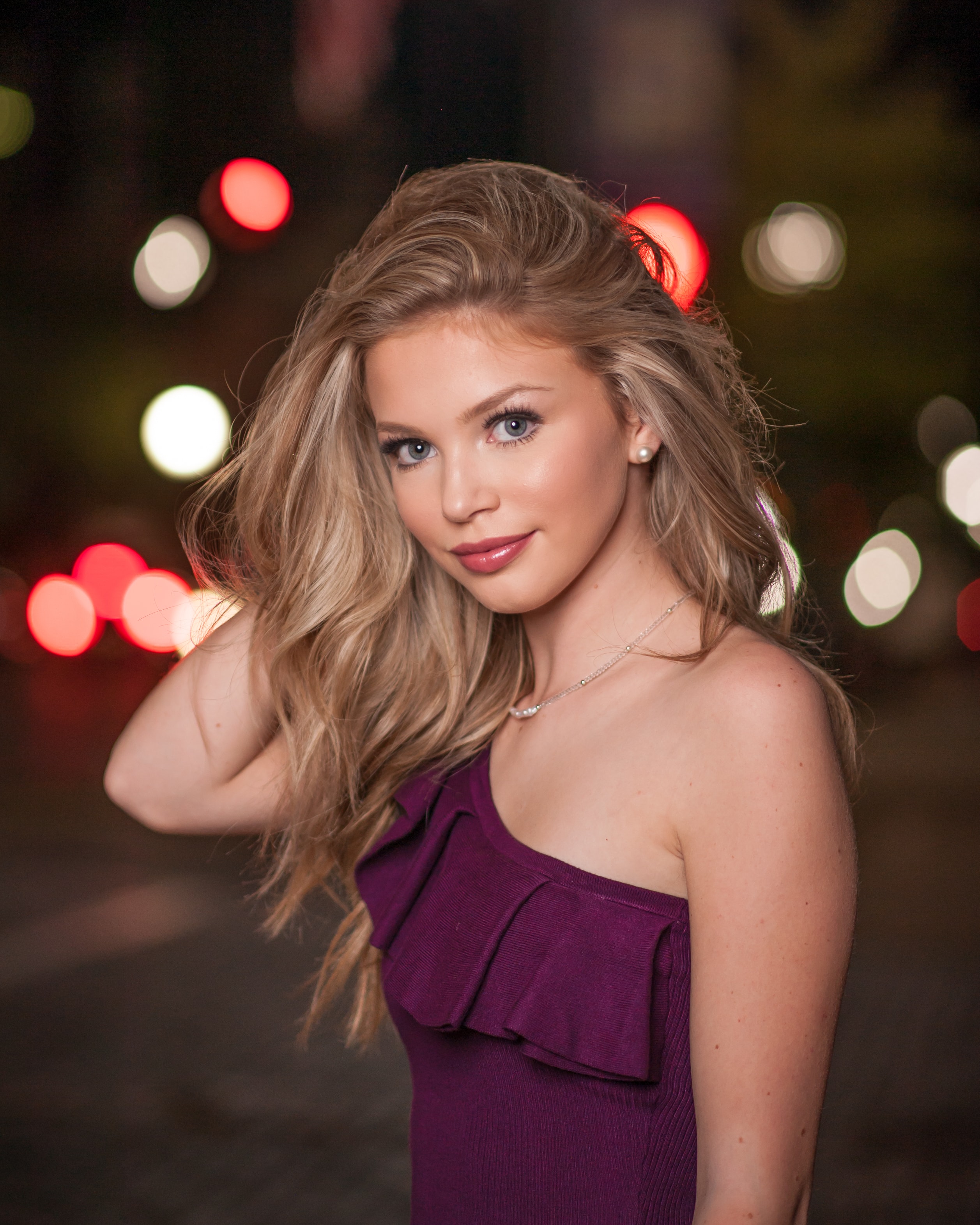 Luxury senior portrait — city lights bokeh night session, Columbus Ohio